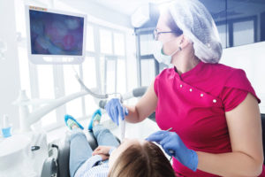Dentist using a intraoral camera on a patient.