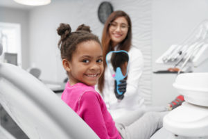 A happy young patient at the dentist.
