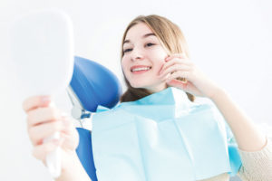 Dental patient admiring her new smile.