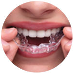 Close up of a lady removing her dental clear aligner.