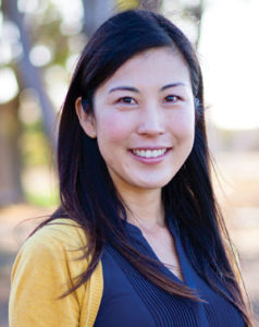 A young lady smiling.